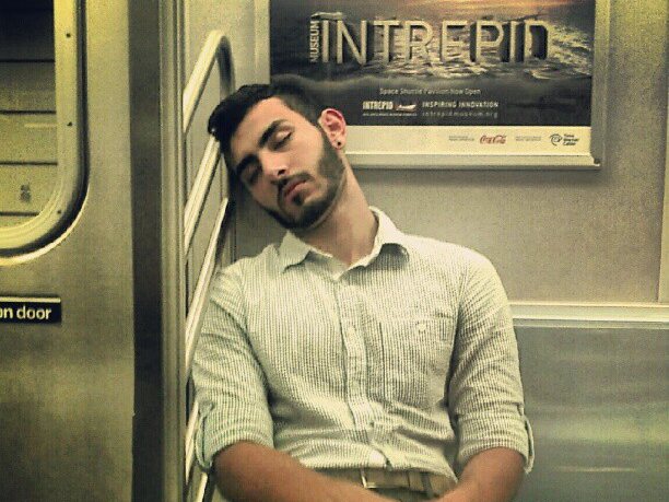 man sleeping on a subway train (flickr by david shankbone)