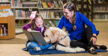 Paws to Read, a reading assistance program offered at libraries around the Peninsula, allows children ranging from just a few years old to the early teens to read to dogs to enhance their skills.