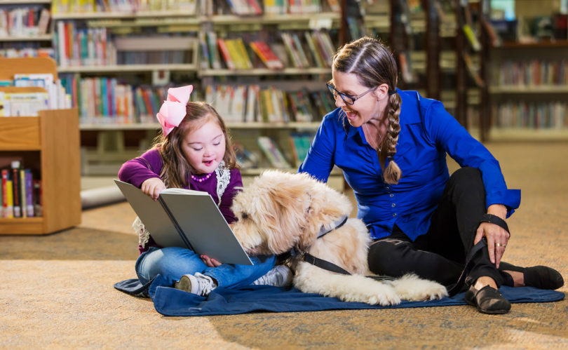 Paws to Read, a reading assistance program offered at libraries around the Peninsula, allows children ranging from just a few years old to the early teens to read to dogs to enhance their skills.